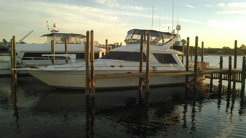 GITSOMRAYS, a 55-foot Sea Ray Sedan Bridge yacht, docked at sunset in Orange Beach